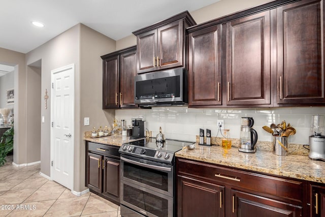 kitchen featuring light stone countertops, tasteful backsplash, and stainless steel appliances