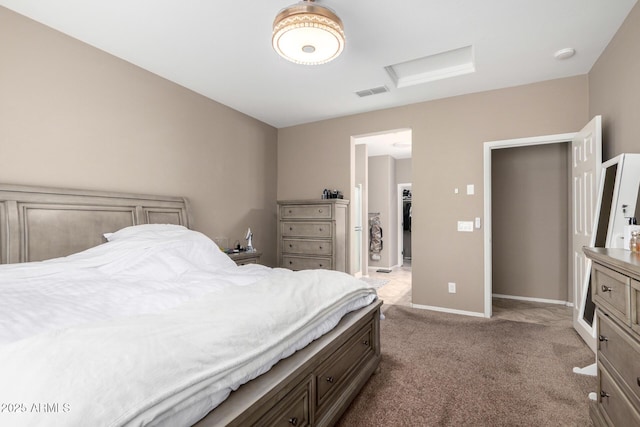 bedroom with baseboards, carpet flooring, attic access, and visible vents