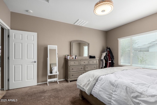 carpeted bedroom featuring baseboards and visible vents