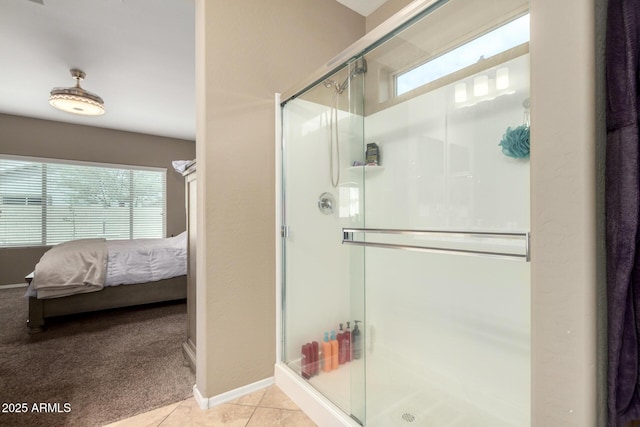 bathroom featuring tile patterned floors, a healthy amount of sunlight, a stall shower, and ensuite bathroom