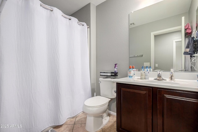 bathroom featuring tile patterned floors, toilet, vanity, and a shower with curtain