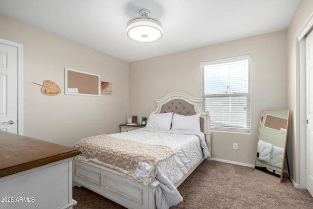 carpeted bedroom featuring baseboards