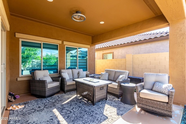 view of patio with an outdoor living space and fence