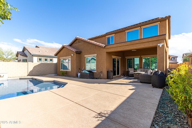 back of property featuring an outdoor living space, a patio area, a fenced backyard, and stucco siding