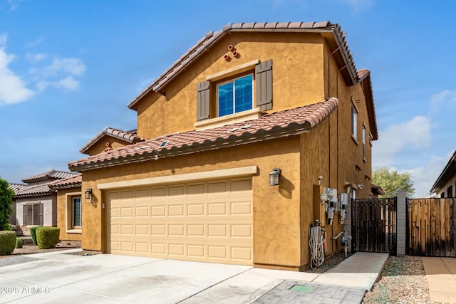 view of front of property featuring a gate, fence, and stucco siding