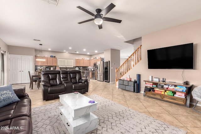 living room featuring ceiling fan and light tile patterned flooring