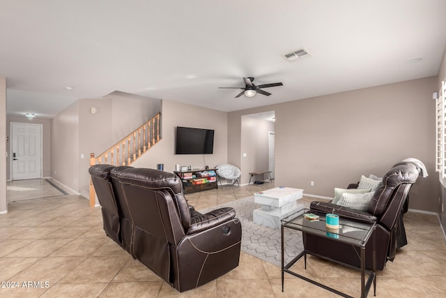 tiled living room with ceiling fan