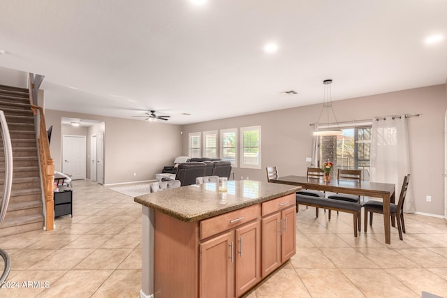 kitchen featuring a kitchen island, hanging light fixtures, plenty of natural light, and ceiling fan