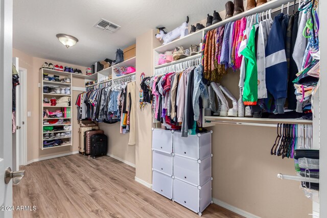 spacious closet featuring light hardwood / wood-style flooring