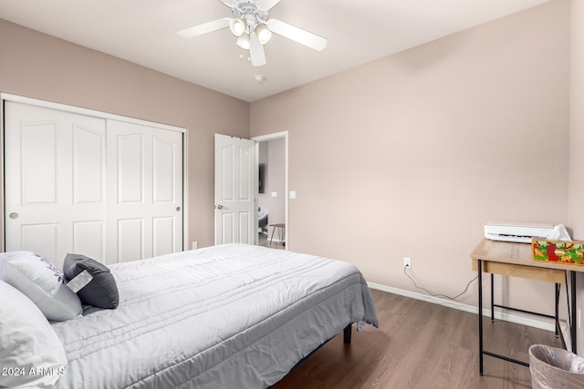 bedroom with hardwood / wood-style floors, ceiling fan, and a closet