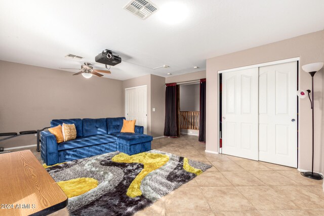 tiled living room featuring ceiling fan