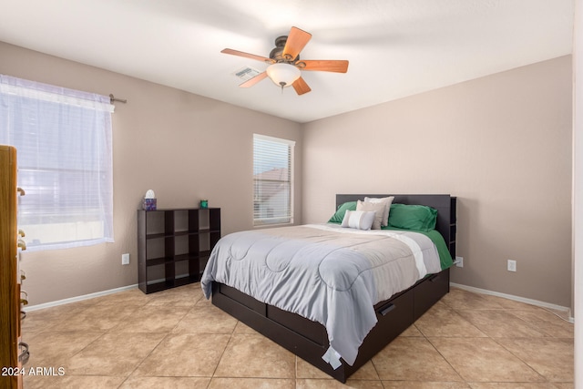 tiled bedroom with ceiling fan