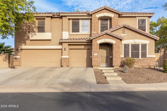 mediterranean / spanish-style home with a garage