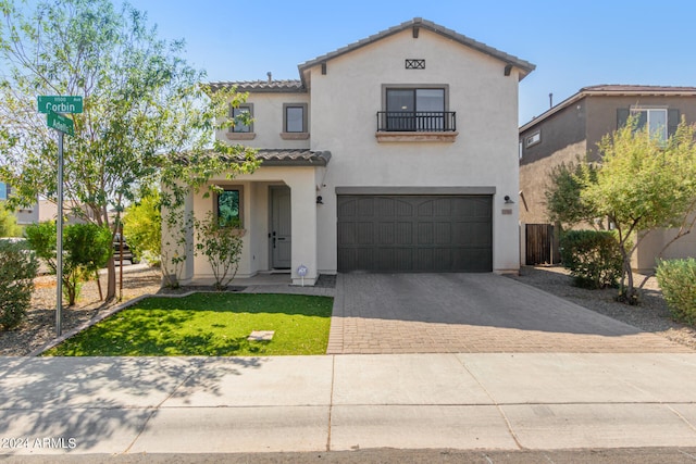 mediterranean / spanish-style home with a garage and a front yard