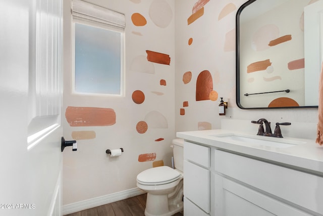 bathroom featuring vanity, toilet, and hardwood / wood-style flooring