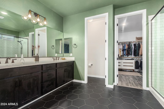 bathroom featuring tile patterned flooring, vanity, and an enclosed shower