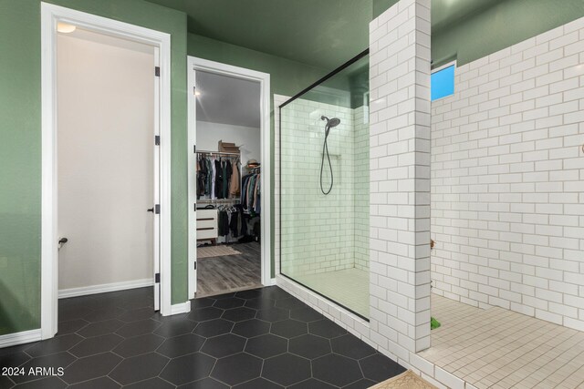 bathroom featuring walk in shower and tile patterned floors