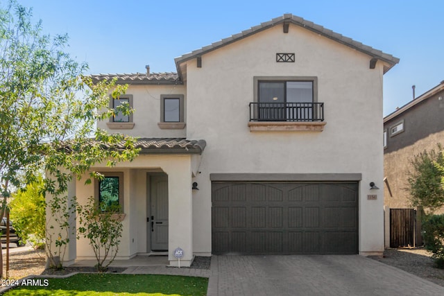 mediterranean / spanish home with a garage