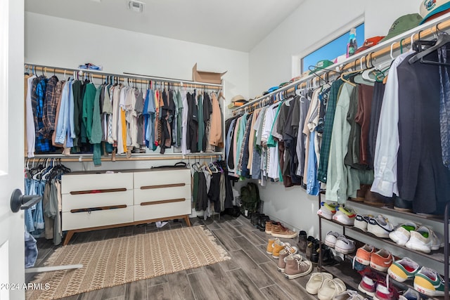 walk in closet with dark hardwood / wood-style floors