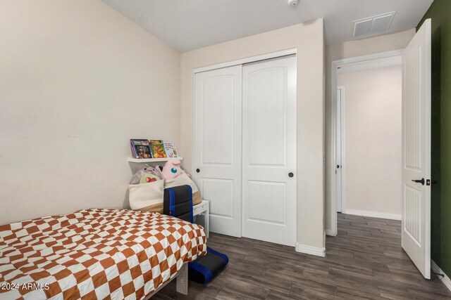 bedroom featuring a closet and dark hardwood / wood-style flooring