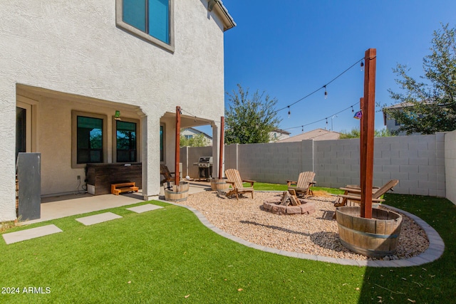 view of yard featuring a patio and an outdoor fire pit