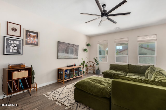 living room featuring ceiling fan and dark hardwood / wood-style floors