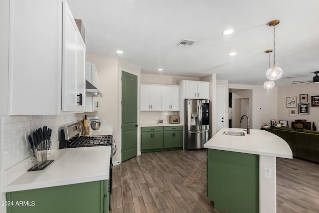 kitchen featuring pendant lighting, sink, stainless steel appliances, green cabinets, and dark hardwood / wood-style flooring