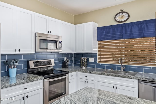 kitchen with sink, stainless steel appliances, and white cabinets