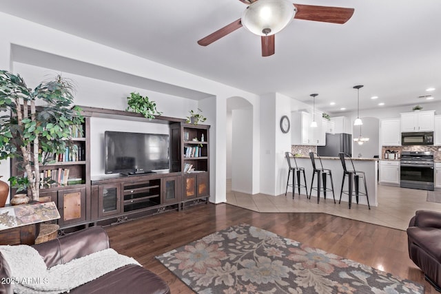 1405 E Aloe Dr, Chandler, AZ 85286 - living area with arched walkways, wood finished floors, a ceiling fan, recessed lighting, and baseboards