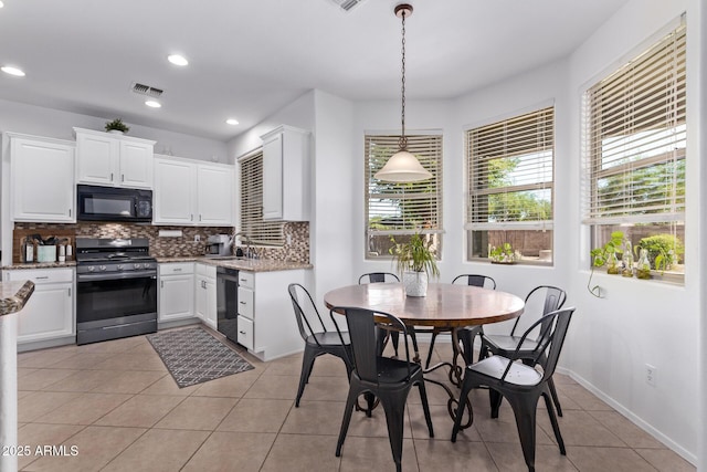 1405 E Aloe Dr, Chandler, AZ 85286 - kitchen featuring black appliances, a sink, backsplash, light tile patterned flooring, and light stone countertops