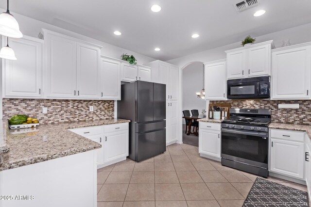 1405 E Aloe Dr, Chandler, AZ 85286 - kitchen featuring freestanding refrigerator, black microwave, gas range, arched walkways, and white cabinetry