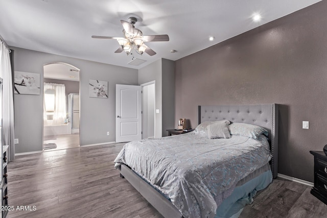 1405 E Aloe Dr, Chandler, AZ 85286 - bedroom featuring arched walkways, wood finished floors, baseboards, ensuite bath, and ceiling fan