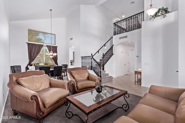 1405 E Aloe Dr, Chandler, AZ 85286 - tiled living room with arched walkways, high vaulted ceiling, stairs, and a chandelier