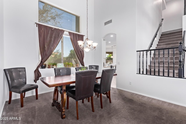 1405 E Aloe Dr, Chandler, AZ 85286 - dining area featuring a chandelier, carpet, a high ceiling, stairway, and baseboards