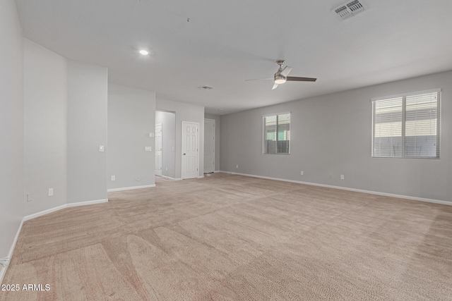 carpeted empty room featuring ceiling fan