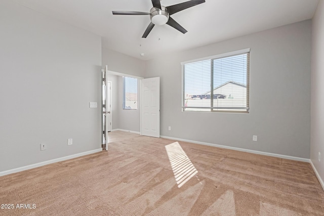 carpeted spare room with ceiling fan