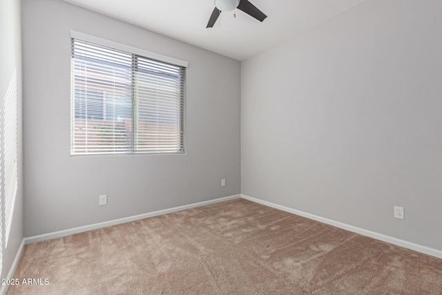 empty room with light colored carpet and ceiling fan