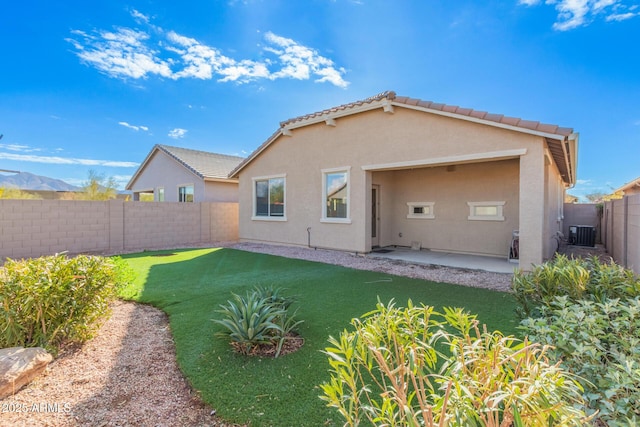 back of house featuring a patio area, central AC unit, and a lawn