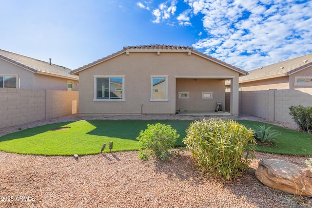 back of property featuring a patio area and a lawn