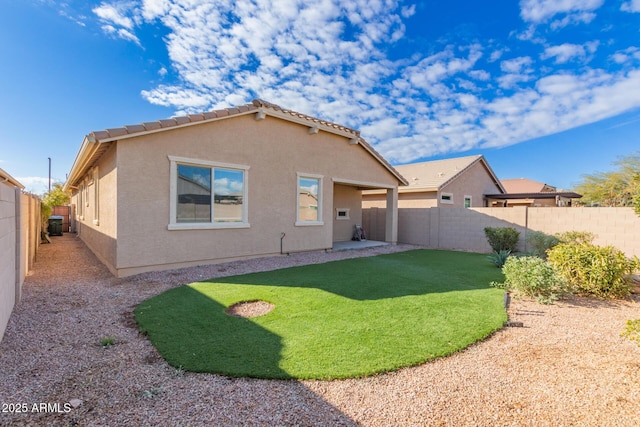 rear view of property featuring a yard