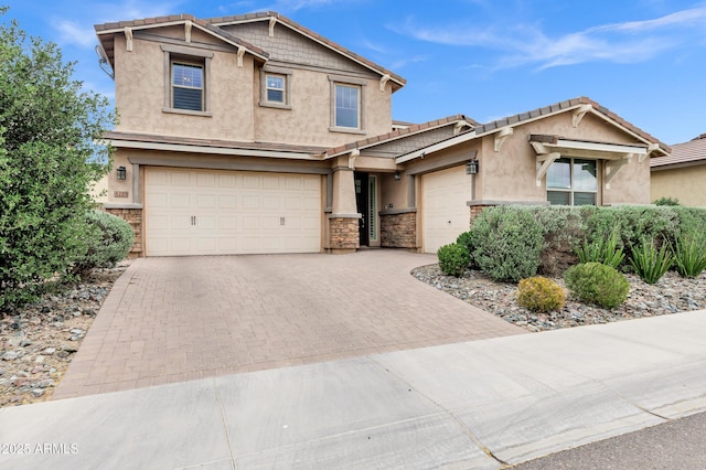 5223 S Axiom, Mesa, AZ 85212 - craftsman-style home with stucco siding, decorative driveway, stone siding, an attached garage, and a tile roof