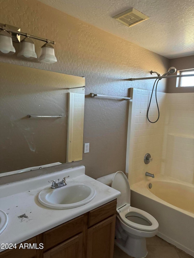 full bathroom with tile patterned floors, shower / bathtub combination, vanity, a textured ceiling, and toilet