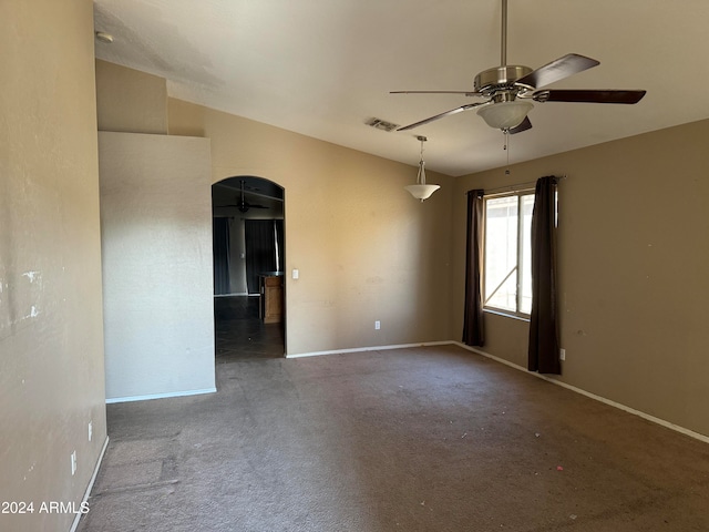 carpeted spare room with ceiling fan and lofted ceiling