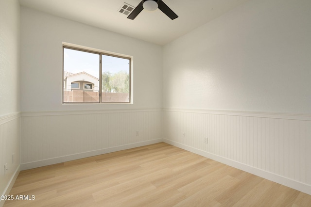 3047 S Chatsworth, Mesa, AZ 85212 - spare room featuring wood finished floors, ceiling fan, a wainscoted wall, and baseboards