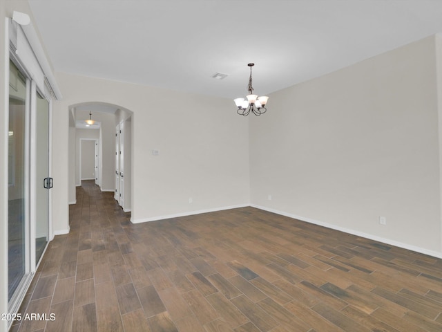 spare room featuring a chandelier