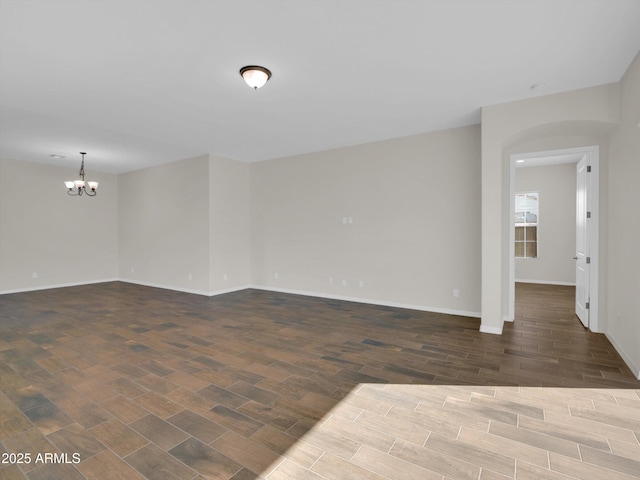 spare room featuring a chandelier