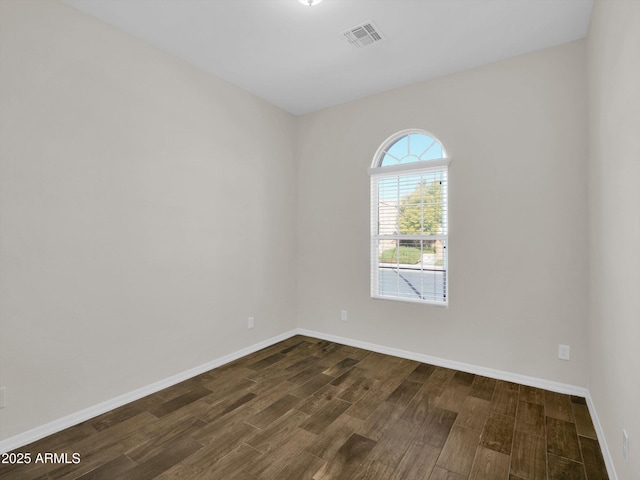 spare room with dark hardwood / wood-style flooring