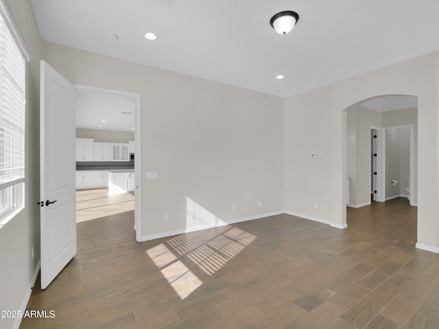 unfurnished room with hardwood / wood-style floors