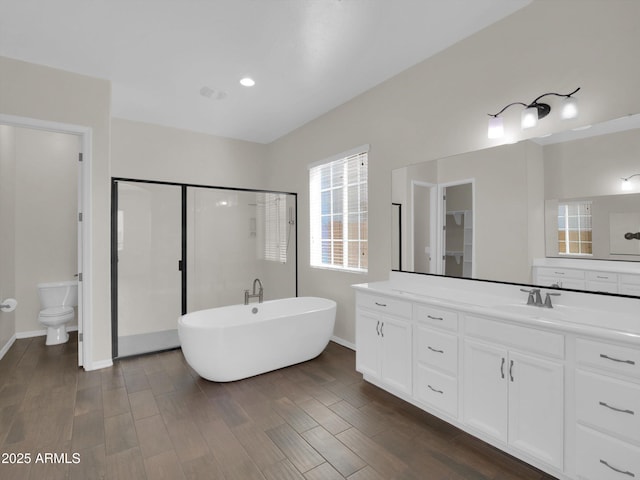 full bathroom featuring vanity, shower with separate bathtub, and toilet