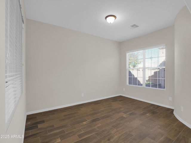 spare room with dark hardwood / wood-style floors